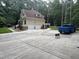 Spacious two-car garage with a large driveway and ample parking, surrounded by lush greenery at 6225 Acorn Ridge Trl, Hillsborough, NC 27278
