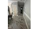 Hallway with designer tile flooring and convenient access to kitchen and bathroom at 6225 Acorn Ridge Trl, Hillsborough, NC 27278