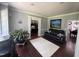 Comfortable living room featuring hardwood floors, a leather sofa, and stylish decor at 6225 Acorn Ridge Trl, Hillsborough, NC 27278