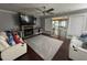 Cozy living room with a stone fireplace, comfortable seating, and a ceiling fan at 6225 Acorn Ridge Trl, Hillsborough, NC 27278