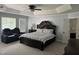 The primary bedroom features a tray ceiling, ceiling fan, a sitting area with a recliner and a private bath at 6225 Acorn Ridge Trl, Hillsborough, NC 27278