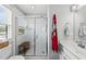 Bright bathroom featuring a glass enclosed shower with white tile and a single sink vanity at 6300 Pleasant Pines Dr # 101, Raleigh, NC 27613