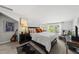 Bright bedroom with a dark wood bed frame, artwork, guitar, and natural light at 6300 Pleasant Pines Dr # 101, Raleigh, NC 27613