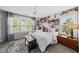 Serene bedroom featuring a cozy bed, natural light, and a floral accent wall at 6300 Pleasant Pines Dr # 101, Raleigh, NC 27613
