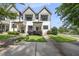 Charming two-story townhouse with gray and white exterior and well-manicured landscaping at 6300 Pleasant Pines Dr # 101, Raleigh, NC 27613