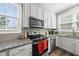 Well-lit kitchen showcasing stainless steel appliances, granite countertops, and white cabinetry at 6300 Pleasant Pines Dr # 101, Raleigh, NC 27613