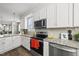 Modern kitchen with stainless appliances, granite countertops and view to the open-concept living space at 6300 Pleasant Pines Dr # 101, Raleigh, NC 27613