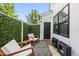 Private patio area with outdoor seating, decorative greenery, and access to the home at 6300 Pleasant Pines Dr # 101, Raleigh, NC 27613