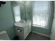 Bright half bathroom with a white vanity, updated fixtures and natural light at 650 Ganyard Farm Way # 32, Durham, NC 27703
