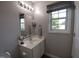 Neutral toned bathroom featuring a window for natural light, vanity, and stylish fixtures at 650 Ganyard Farm Way # 32, Durham, NC 27703
