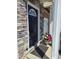Inviting front porch with stone accents, flower pot and covered entry at 650 Ganyard Farm Way # 32, Durham, NC 27703