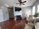 Spacious living room featuring a fireplace, modern ceiling fan, and hardwood floors at 650 Ganyard Farm Way # 32, Durham, NC 27703