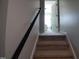 Ascend the carpeted staircase, leading to the upper level and bedrooms at 650 Ganyard Farm Way # 32, Durham, NC 27703