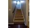 Carpeted staircase with dark wood handrail and neutral paint at 650 Ganyard Farm Way # 32, Durham, NC 27703