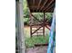 View of the overgrown backyard with a wooden frame against the wooded lot at 651 Berry Chase Way, Cary, NC 27519