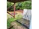 Backyard view of a garden with a wooden frame, white fence and overhead deck at 651 Berry Chase Way, Cary, NC 27519