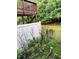Backyard features a garden space with a deck overhead and a partial white fence at 651 Berry Chase Way, Cary, NC 27519