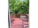 View of the deck with a swing and seating, overlooking lush greenery at 651 Berry Chase Way, Cary, NC 27519
