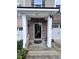 Brick townhouse with well-lit entryway and covered porch featuring the house number at 651 Berry Chase Way, Cary, NC 27519