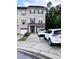 Exterior view of a modern townhouse with ample parking and green landscaping at 651 Berry Chase Way, Cary, NC 27519