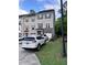 Townhouse with a driveway featuring two parked cars and manicured lawn at 651 Berry Chase Way, Cary, NC 27519