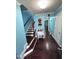 Inviting foyer featuring hardwood floors, staircase, and charming decor details at 651 Berry Chase Way, Cary, NC 27519