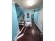 Inviting foyer featuring hardwood floors, staircase, and charming decor details at 651 Berry Chase Way, Cary, NC 27519