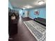 Spacious living room with laminate wood floors, blue walls, and ample lighting at 651 Berry Chase Way, Cary, NC 27519