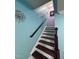 Staircase featuring wood treads and railing, with a blue accent wall at 651 Berry Chase Way, Cary, NC 27519