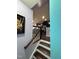 Staircase leading to kitchen with modern cabinetry and stainless appliances at 651 Berry Chase Way, Cary, NC 27519