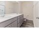 Modern bathroom featuring double sinks, granite countertops and gray cabinets at 706 Ambrose Hill Lane Ln, Wendell, NC 27591
