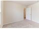 Bedroom with neutral carpeting, ample lighting, and a welcoming doorway at 706 Ambrose Hill Lane Ln, Wendell, NC 27591