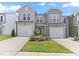 Well-maintained townhomes featuring attached garages, lush lawns, and inviting entrances at 706 Ambrose Hill Lane Ln, Wendell, NC 27591