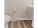 Clean and modern half bathroom featuring a pedestal sink, neutral paint and wood-style flooring at 706 Ambrose Hill Lane Ln, Wendell, NC 27591
