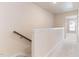 Hallway and staircase with neutral walls and plush carpeting throughout the house at 706 Ambrose Hill Lane Ln, Wendell, NC 27591