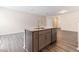 Kitchen island featuring stainless steel appliances, a sink, gray cabinets and granite countertops at 706 Ambrose Hill Lane Ln, Wendell, NC 27591