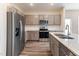 Contemporary kitchen with stainless steel appliances, granite counters, and gray cabinetry at 706 Ambrose Hill Lane Ln, Wendell, NC 27591