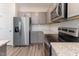 Modern kitchen featuring stainless steel appliances, granite countertops and gray cabinets at 706 Ambrose Hill Lane Ln, Wendell, NC 27591