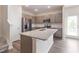 Modern kitchen showcasing gray cabinets, granite countertops, and stainless steel appliances at 706 Ambrose Hill Lane Ln, Wendell, NC 27591