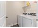 Well-lit laundry room with new appliances, shelving, and durable flooring at 706 Ambrose Hill Lane Ln, Wendell, NC 27591