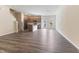Open-concept living room with wood-look flooring and a view of the modern kitchen at 706 Ambrose Hill Lane Ln, Wendell, NC 27591