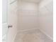 Spacious walk-in closet with white wire shelving and neutral carpeting, ready for organization at 706 Ambrose Hill Lane Ln, Wendell, NC 27591