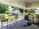 Outdoor back porch features comfortable seating and ceiling fan overlooking the private backyard at 712 E Horne St, Clayton, NC 27520