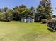 Large backyard features two storage sheds surrounded by mature shade trees in a serene setting at 712 E Horne St, Clayton, NC 27520