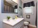 Bathroom features a white vanity, framed mirror, framed artwork, and a shower with gray curtain at 712 E Horne St, Clayton, NC 27520