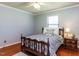 Bedroom features hardwood floors, a bed with blue patterned bedding, and ceiling fan at 712 E Horne St, Clayton, NC 27520
