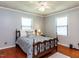 Bedroom features hardwood floors, bed with blue patterned bedding, and a ceiling fan at 712 E Horne St, Clayton, NC 27520