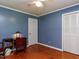 This bedroom features hardwood floors, a ceiling fan, and double door closet for ample storage at 712 E Horne St, Clayton, NC 27520