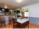 Open dining room with wooden table, chairs, and view of the kitchen at 712 E Horne St, Clayton, NC 27520