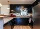 Functional kitchen featuring dark wood cabinetry, tile backsplash and stainless steel appliances at 712 E Horne St, Clayton, NC 27520